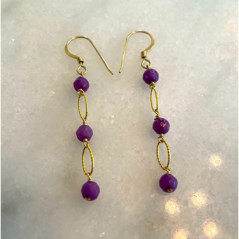 Gold earrings with purple stone